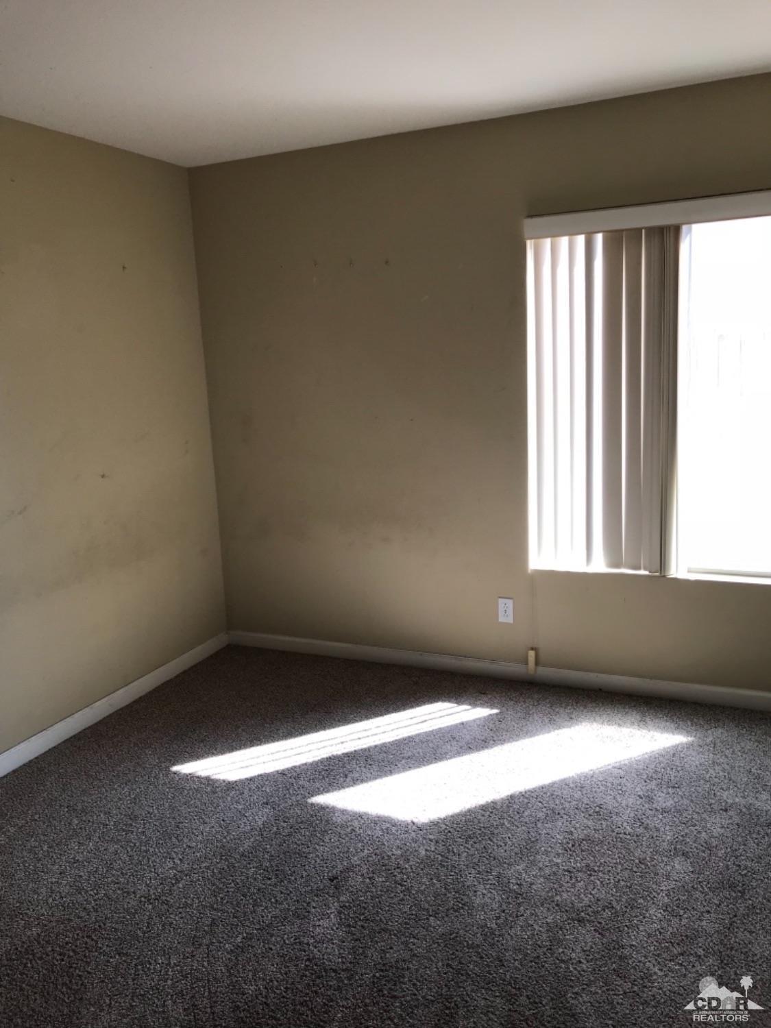 49084 Violet Street Indio, CA 92201 - Photo 8 of 14 a view of an empty room with a window