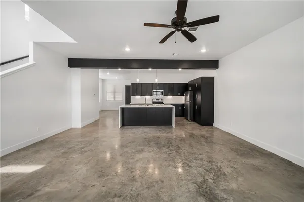a living room with furniture and a ceiling fan