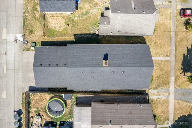 an aerial view of a house with garden space and street view
