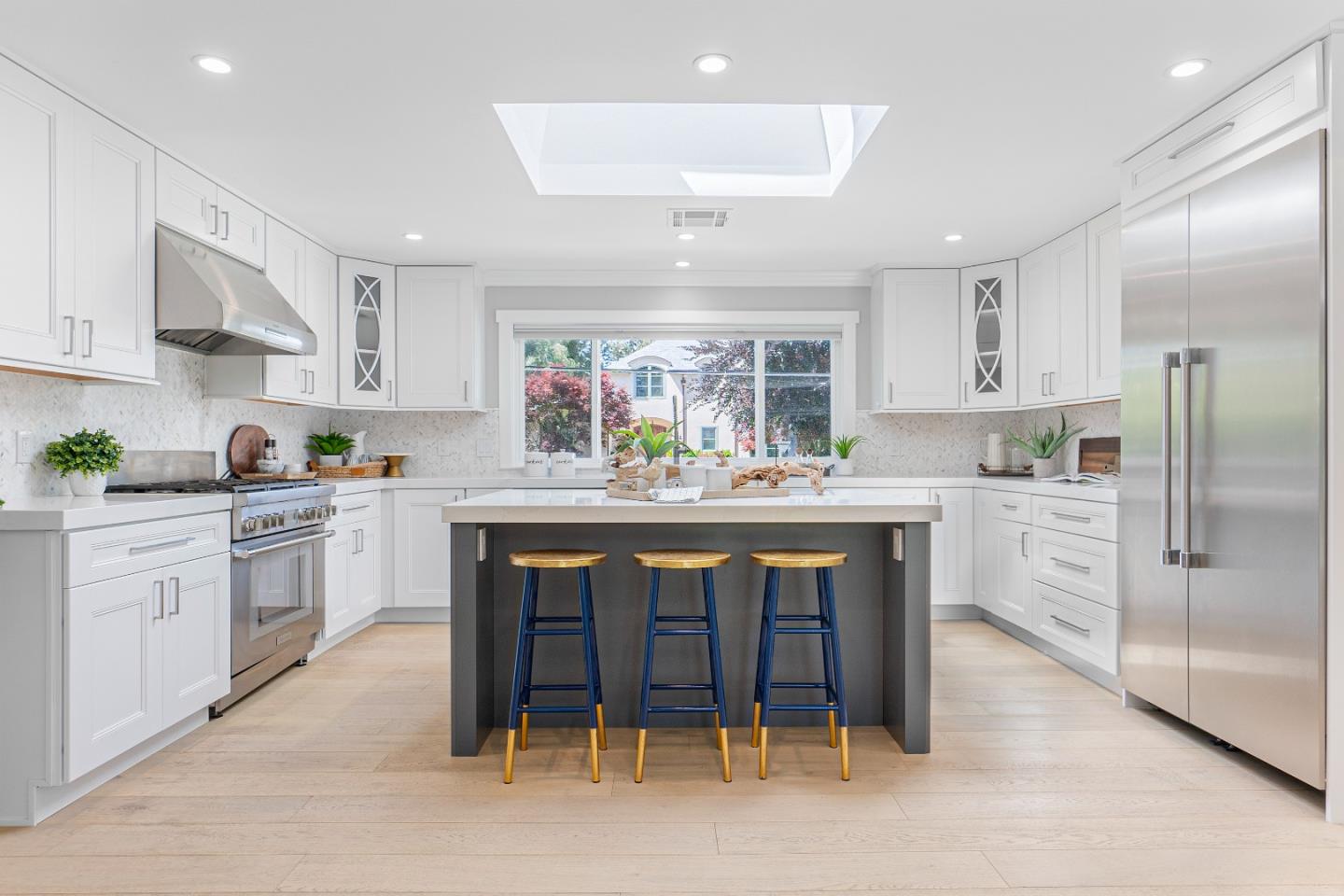 928 Manor Way Los Altos, CA 94024 - Photo 13 of 41 a kitchen with stainless steel appliances granite countertop a table chairs sink refrigerator and cabinets