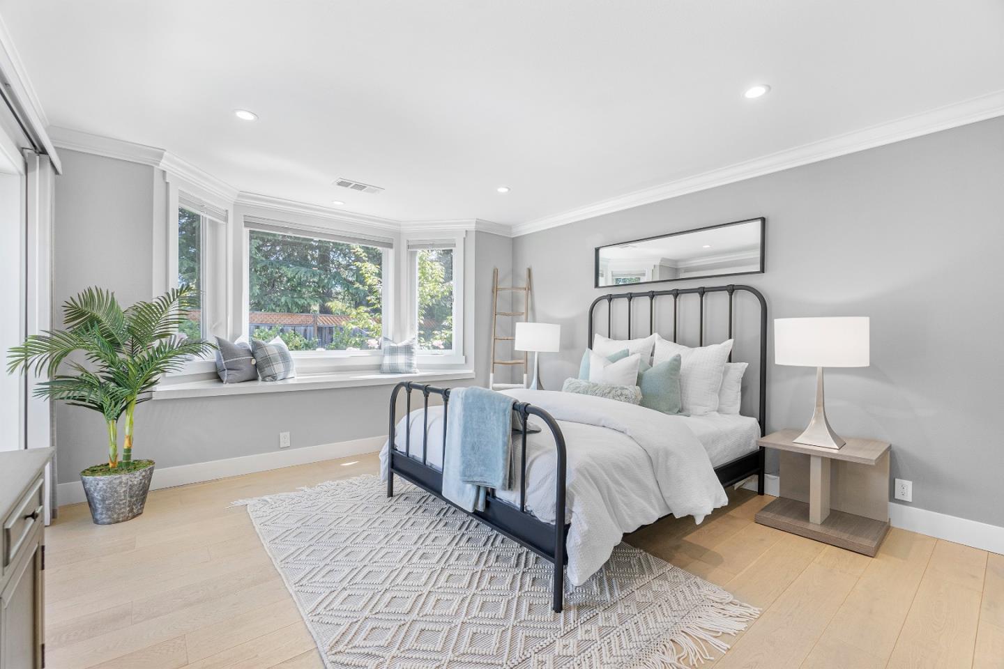 928 Manor Way Los Altos, CA 94024 - Photo 33 of 41 a spacious bedroom with a large bed and a potted plant