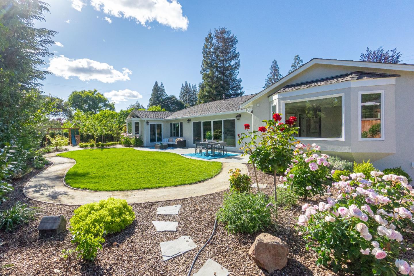 928 Manor Way Los Altos, CA 94024 - Photo 38 of 41 a view of a white house with a yard and potted plants
