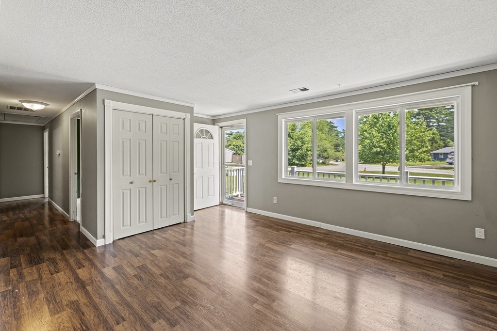 13 Naushon Road West Wareham, MA 02576 - Photo 3 of 29 a view of an empty room with wooden floor and a window