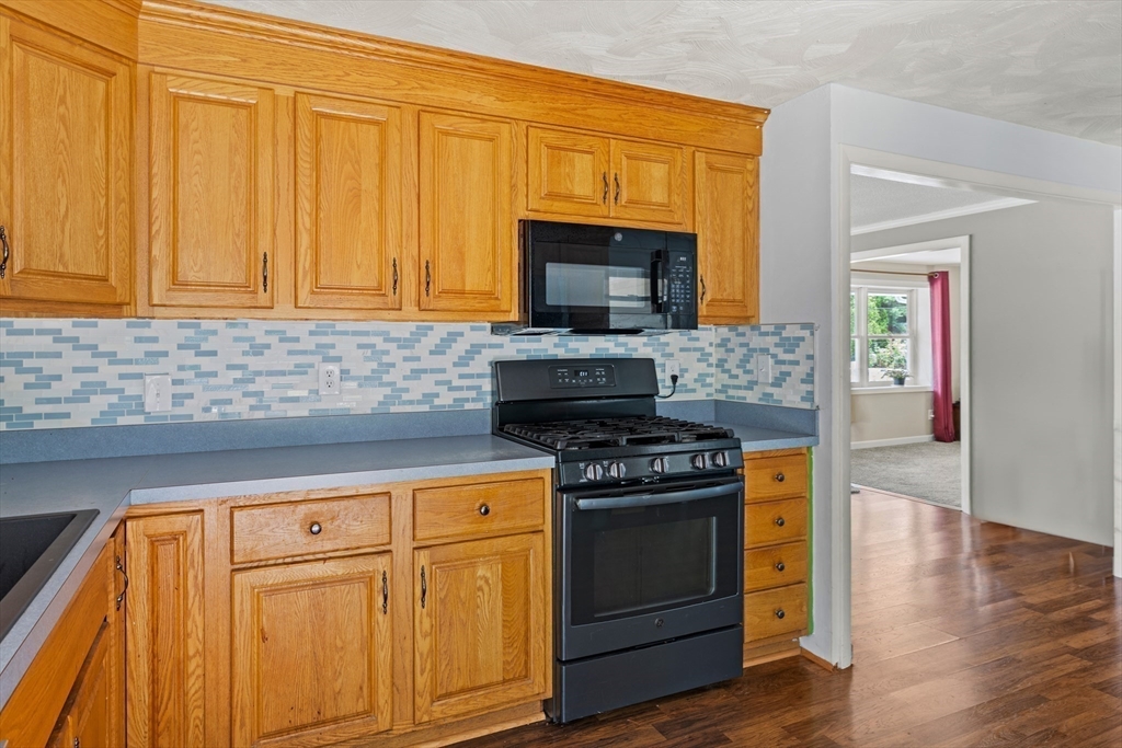 13 Naushon Road West Wareham, MA 02576 - Photo 6 of 29 a kitchen with granite countertop cabinets stainless steel appliances and wooden floor