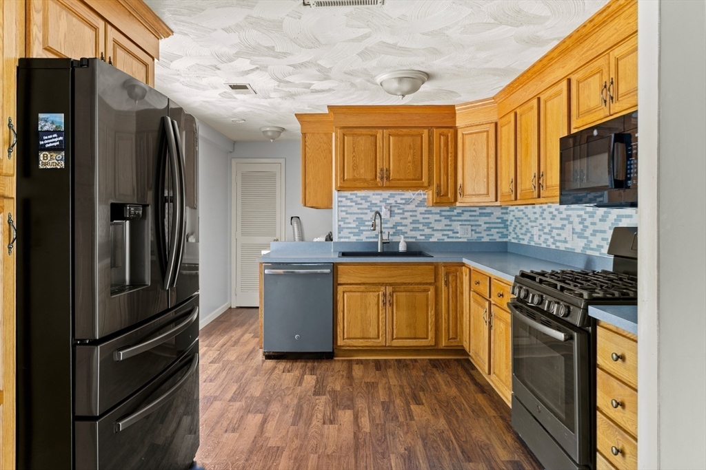 13 Naushon Road West Wareham, MA 02576 - Photo 7 of 29 a kitchen with granite countertop a refrigerator stove top oven and sink