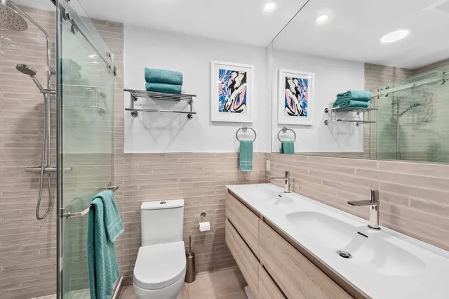 a bathroom with a toilet sink and mirror