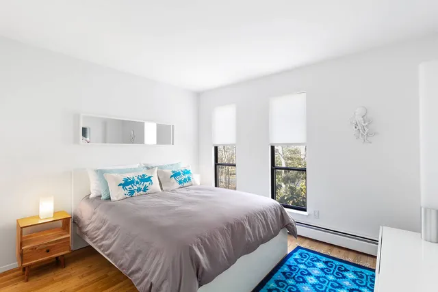 a bed sitting in a bedroom next to a window