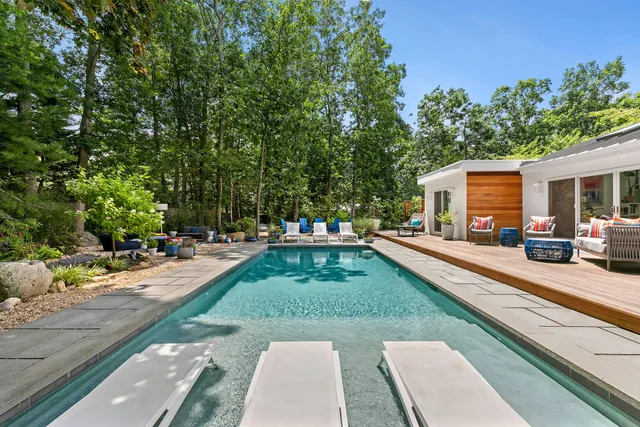 a swimming pool view with a sitting space