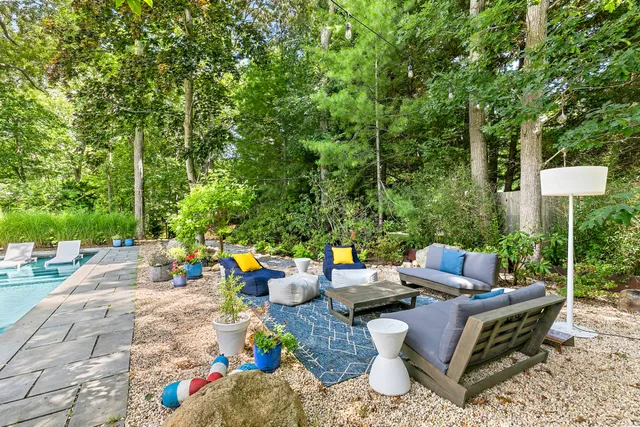 a view of a backyard with sitting area