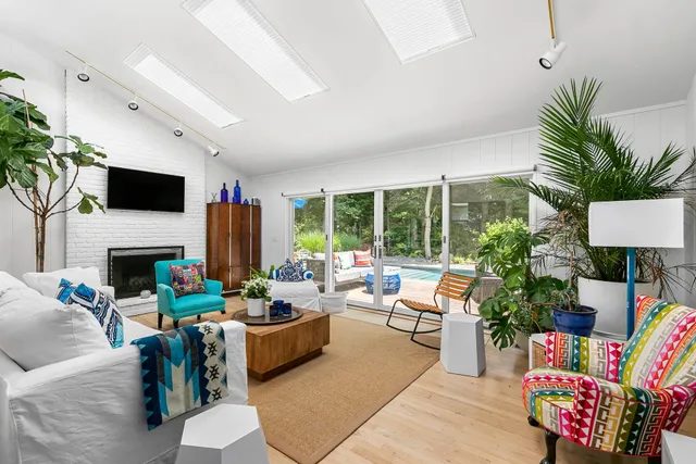 a living room with furniture fireplace and a large window