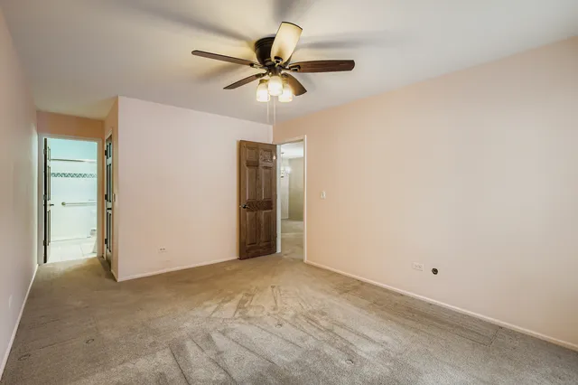 a view of a room with a ceiling fan