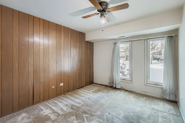 a view of a livingroom with a ceiling fan and window