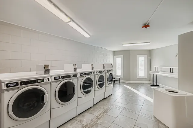 a utility room with sink dryer and washer