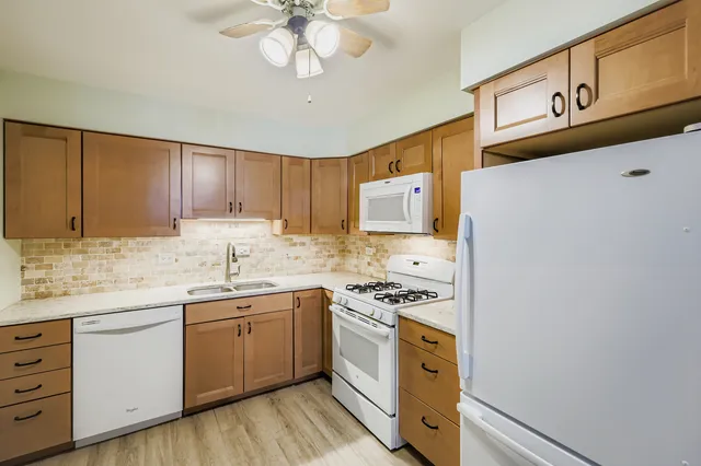 a kitchen with stainless steel appliances a sink stove and cabinets