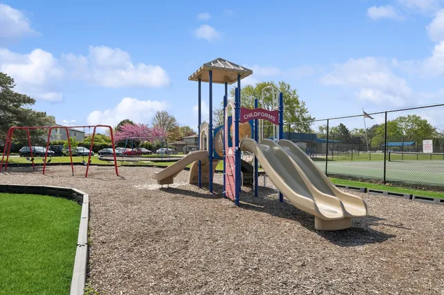 a view of a grassy field with trees around