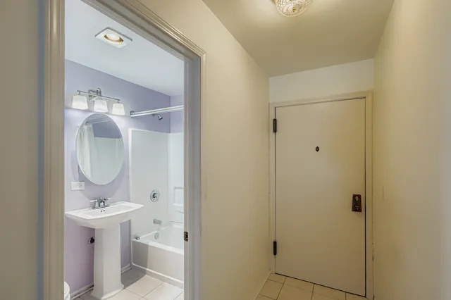 a bathroom with a sink a mirror and shower