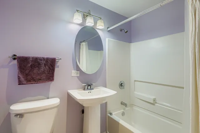 a bathroom with a sink toilet and a mirror