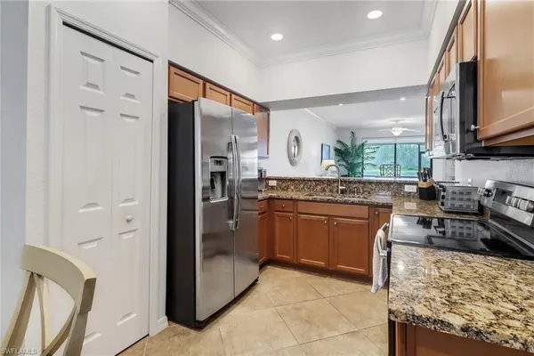 a kitchen with stainless steel appliances granite countertop a refrigerator stove and sink