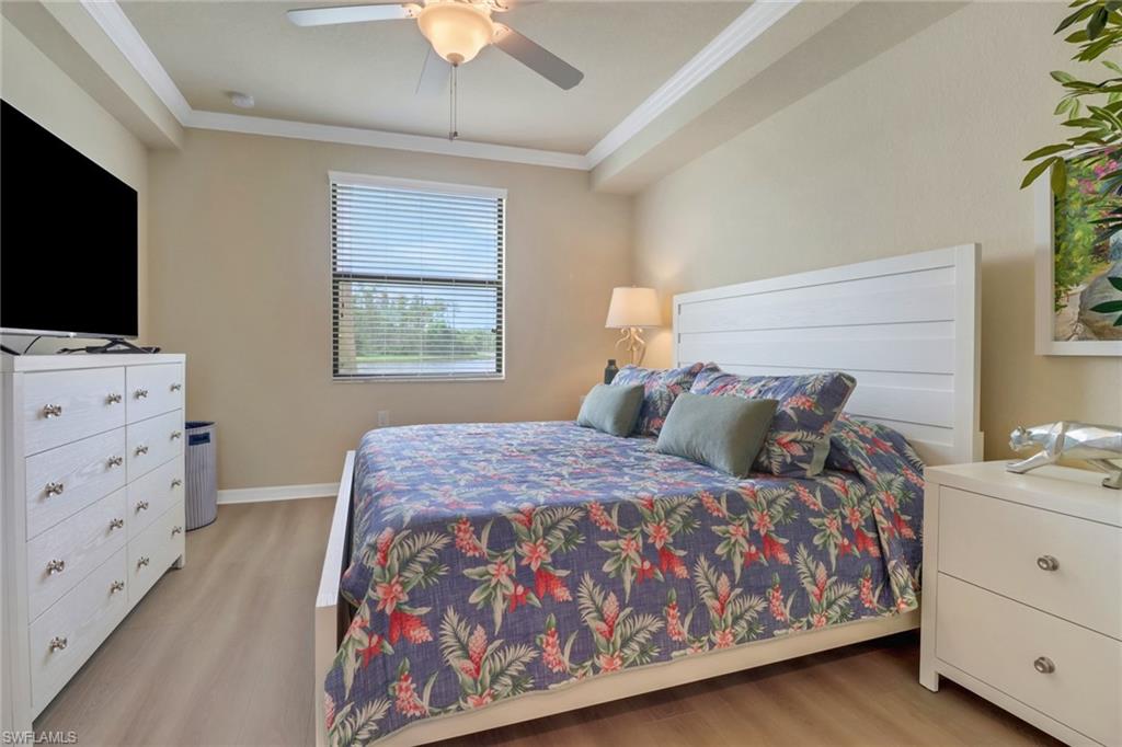 9560 Trevi Court, Unit 4814 Naples, FL 34113 - Photo 14 of 42 a bedroom with a bed and a flat screen tv