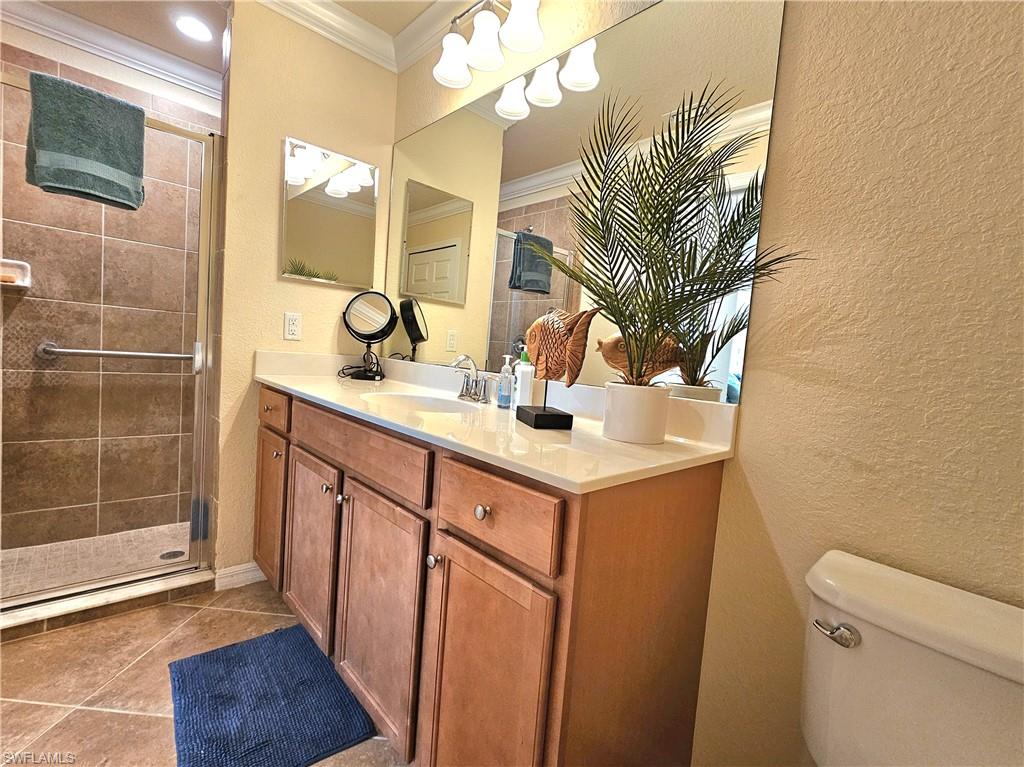 9560 Trevi Court, Unit 4814 Naples, FL 34113 - Photo 16 of 42 a bathroom with a sink a toilet and mirror