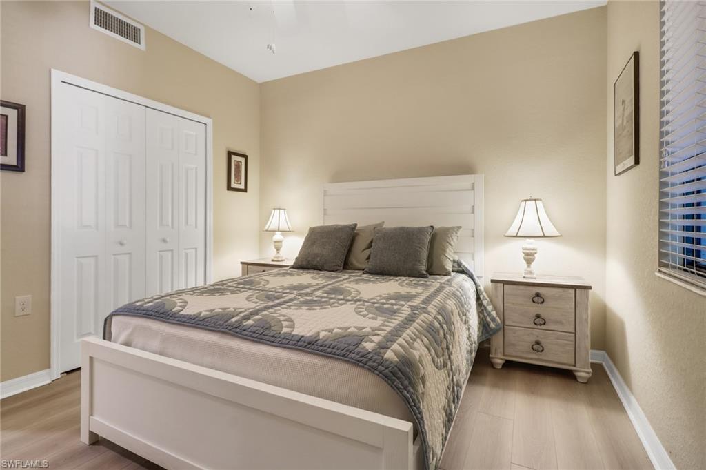 9560 Trevi Court, Unit 4814 Naples, FL 34113 - Photo 18 of 42 a bedroom with a bed and a refrigerator