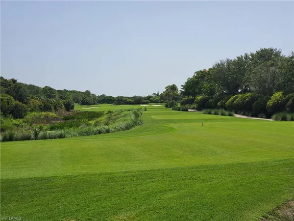 a view of a porch with a table and chairs