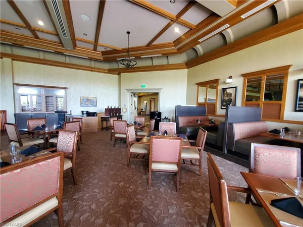 a living room with furniture a large window and chairs