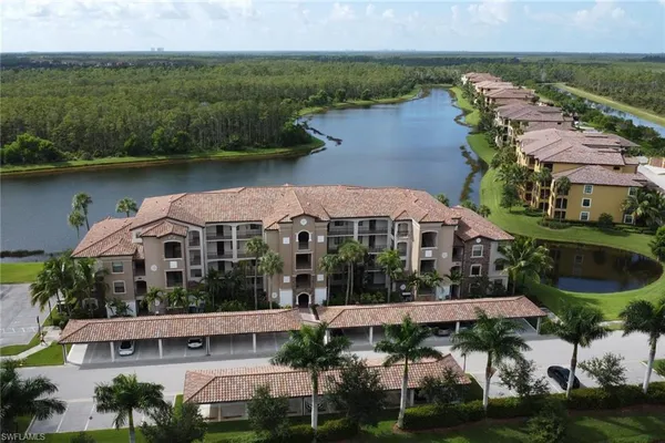 an aerial view of a house with a garden and lake view