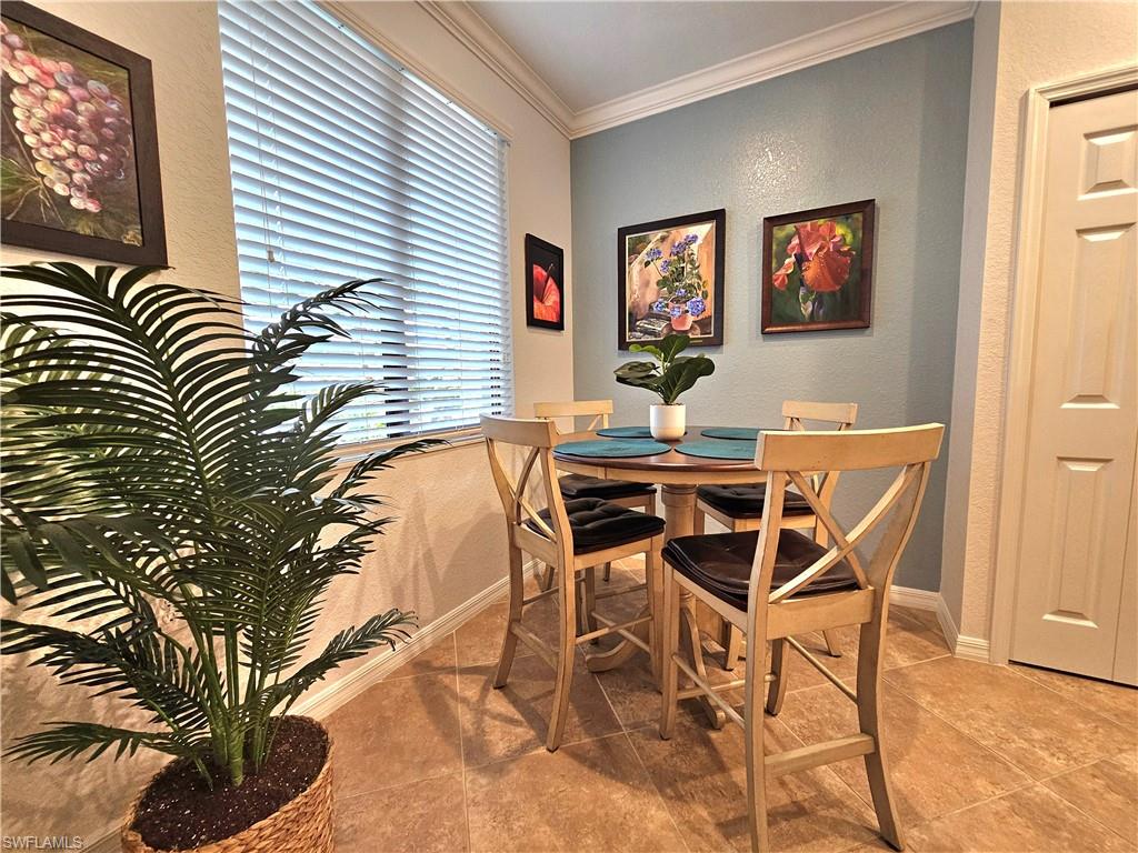 9560 Trevi Court, Unit 4814 Naples, FL 34113 - Photo 10 of 42 a view of a dining room with furniture and a window