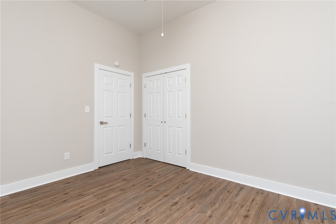 9800 Golf Course Drive Disputanta, VA 23842 - Photo 13 of 19 a view of an empty room with wooden floor