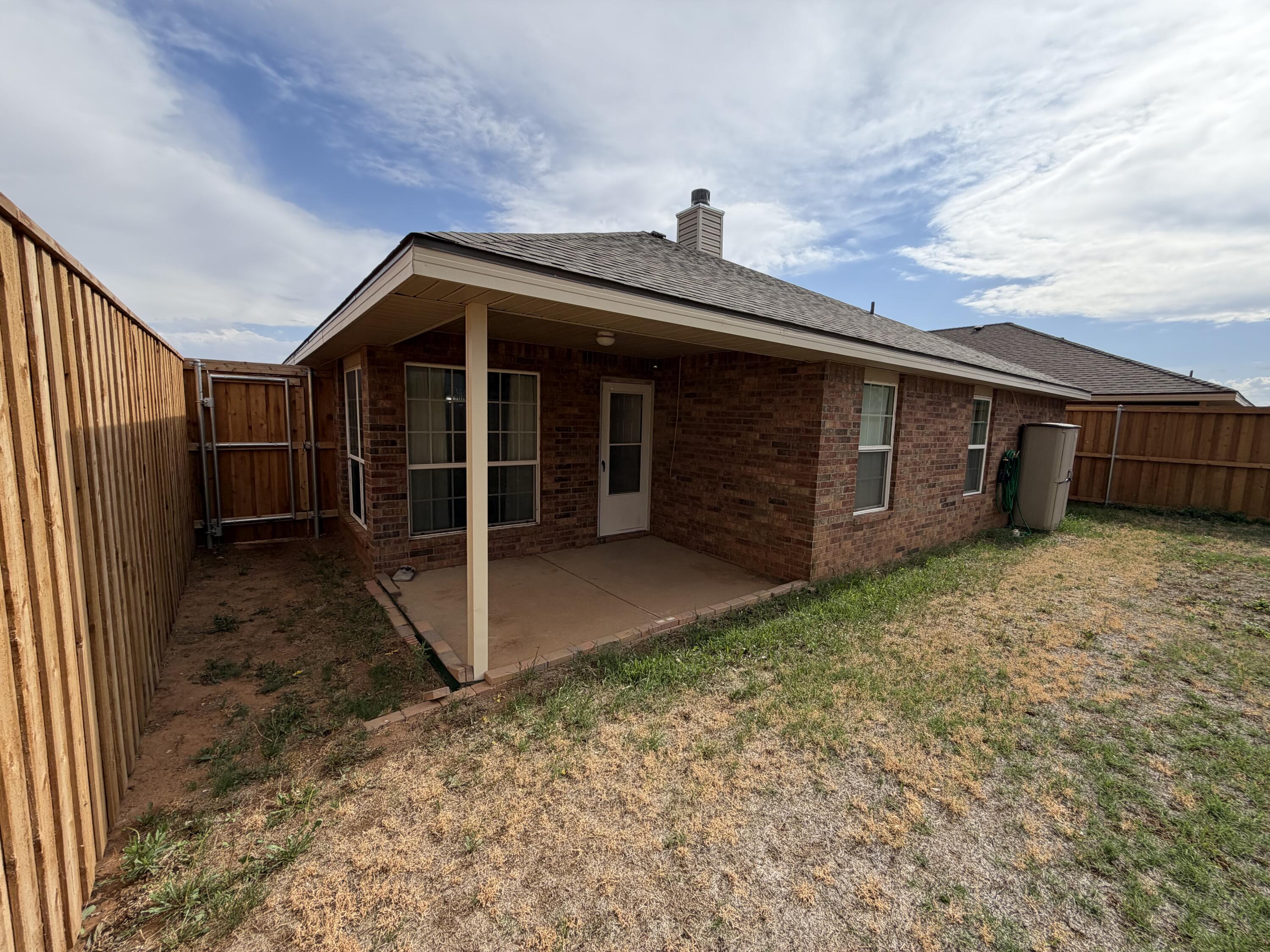 6544 84th Street Lubbock, TX 79424 - Photo 2 of 29 a view of a house with a yard and wooden fence