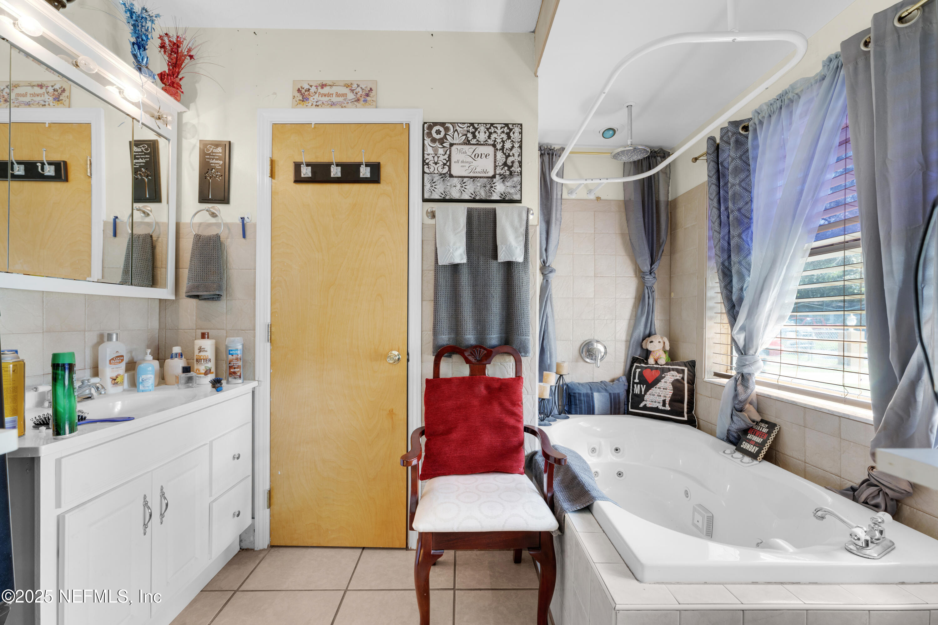 5845 Ransom Street Jacksonville, FL 32211 - Photo 15 of 23 a bathroom with a tub sink and mirror