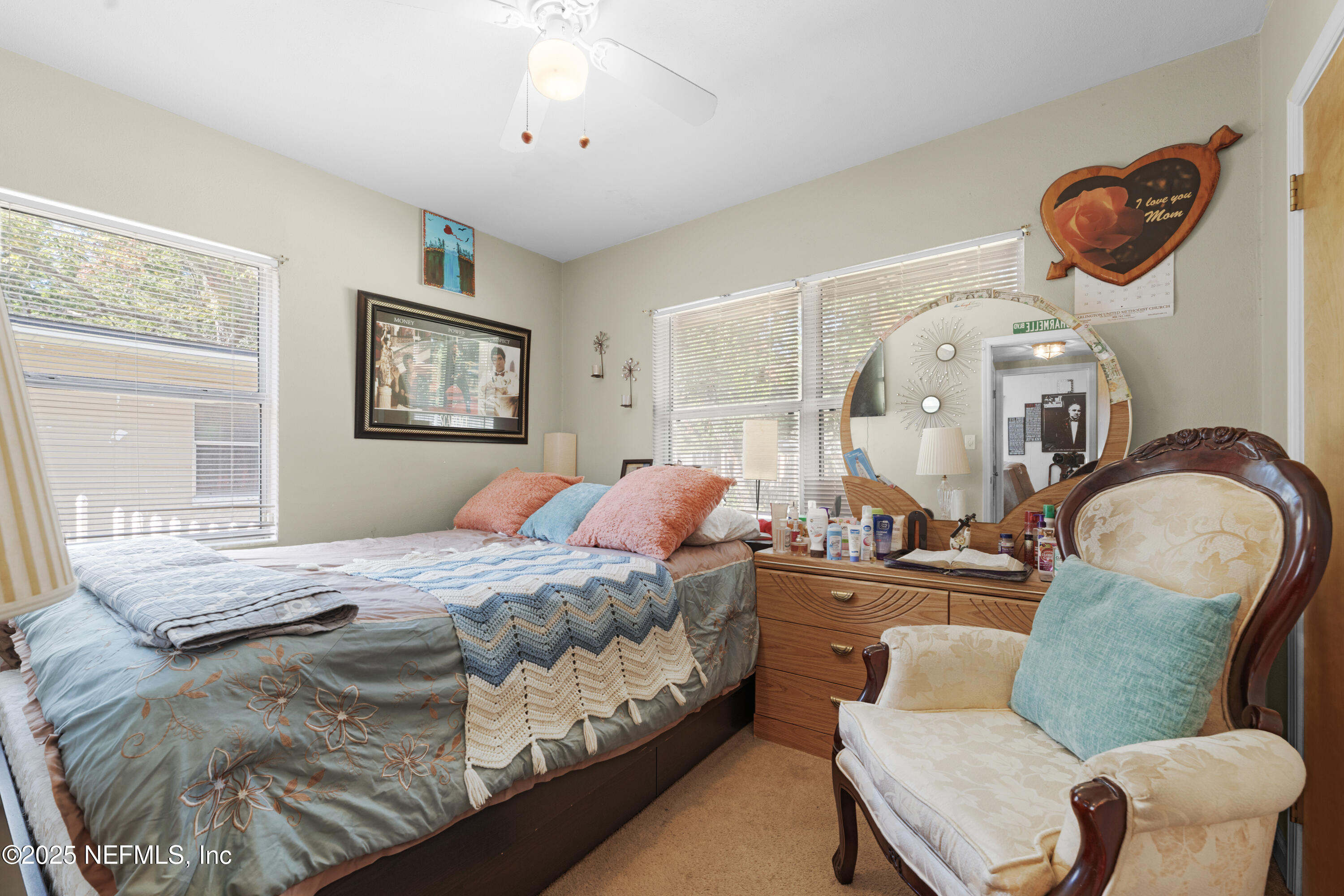 5845 Ransom Street Jacksonville, FL 32211 - Photo 19 of 23 a bedroom with a bed mirror and window