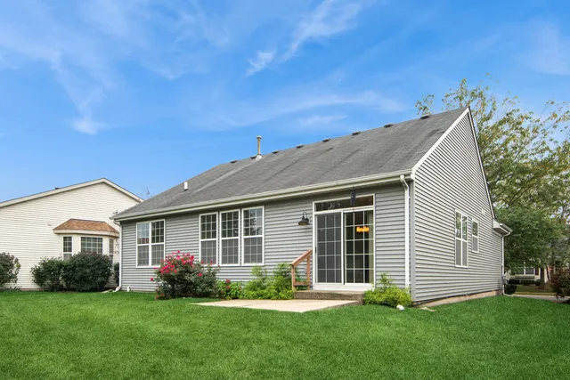 a front view of a house with a garden and yard