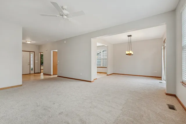 an empty room with a empty space and windows