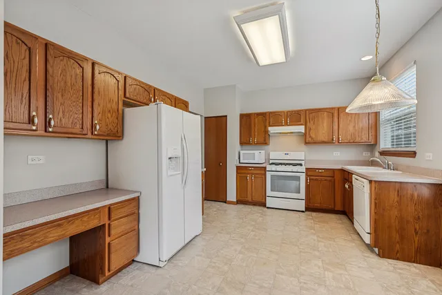a kitchen with stainless steel appliances granite countertop a stove and a refrigerator