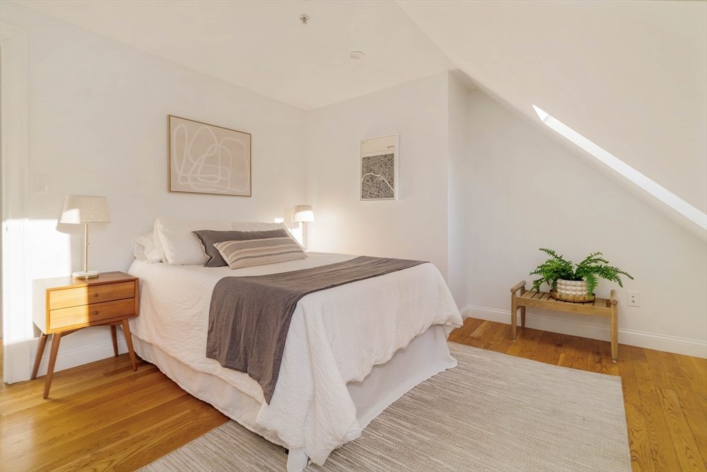 59 Berkeley Street, Unit 3 Somerville, MA 02143 - Photo 14 of 18 a bedroom with a bed and painting on the wall