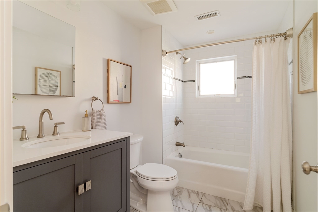 59 Berkeley Street, Unit 3 Somerville, MA 02143 - Photo 15 of 18 a bathroom with a sink toilet and shower