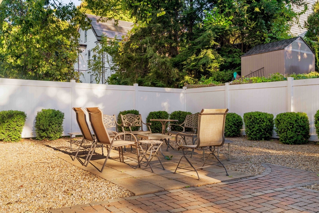 59 Berkeley Street, Unit 3 Somerville, MA 02143 - Photo 17 of 18 a view of a patio with table and chairs potted plants