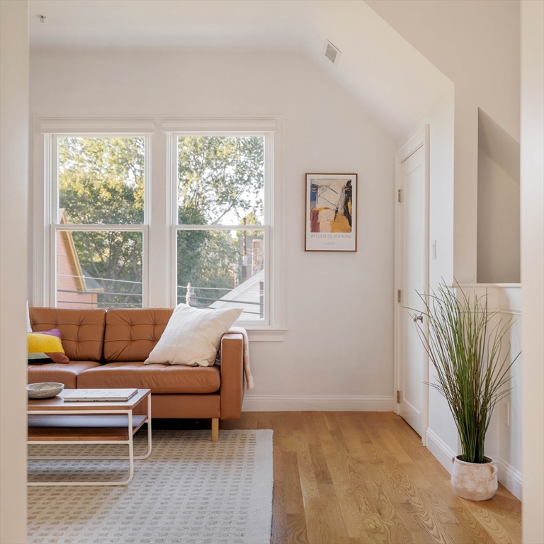 59 Berkeley Street, Unit 3 Somerville, MA 02143 - Photo 2 of 18 a living room with furniture and a large window