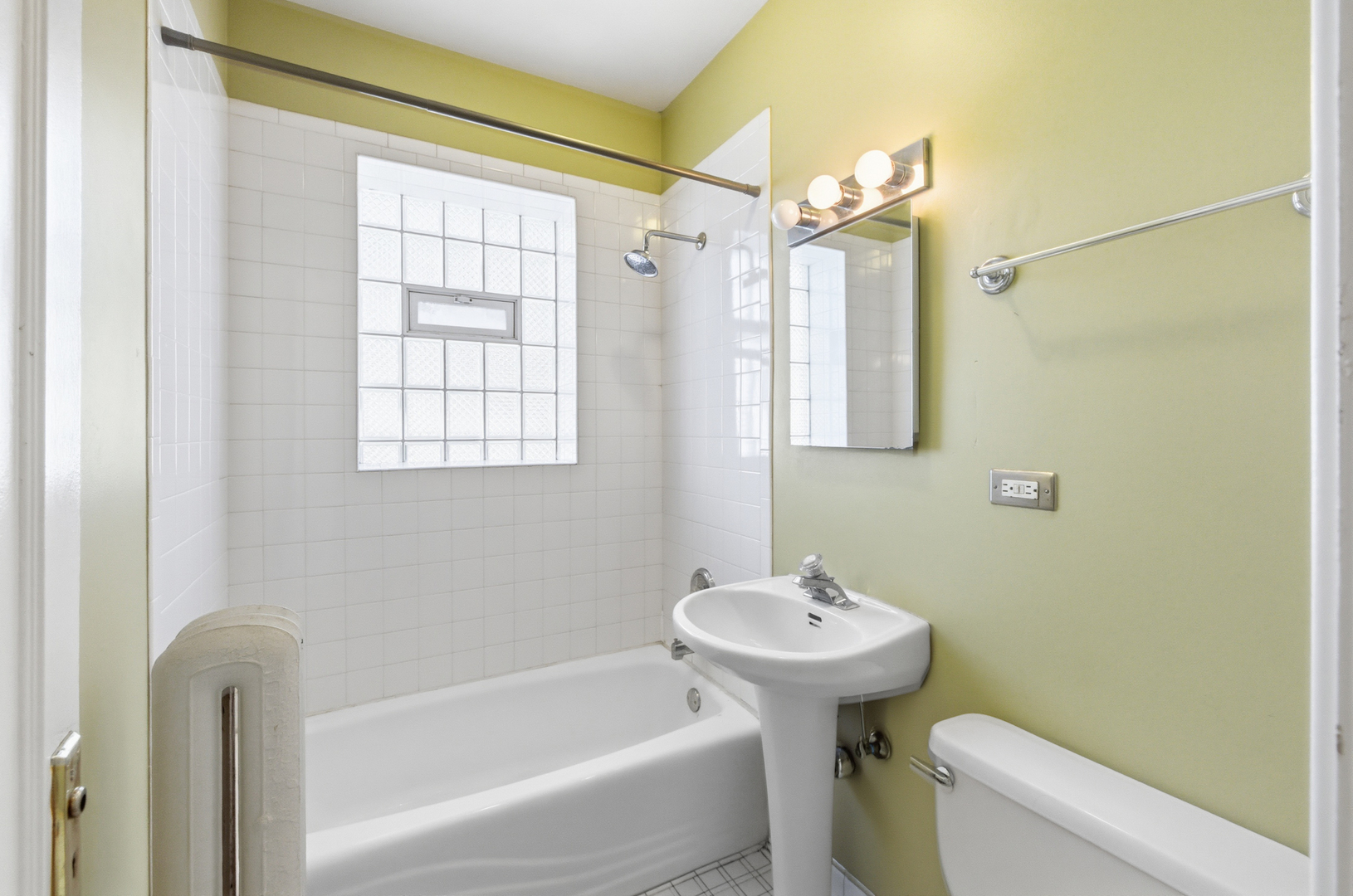 1014 West Barry Avenue, Unit 1 Chicago, IL 60657 - Photo 11 of 17 a bathroom with a sink a toilet and shower