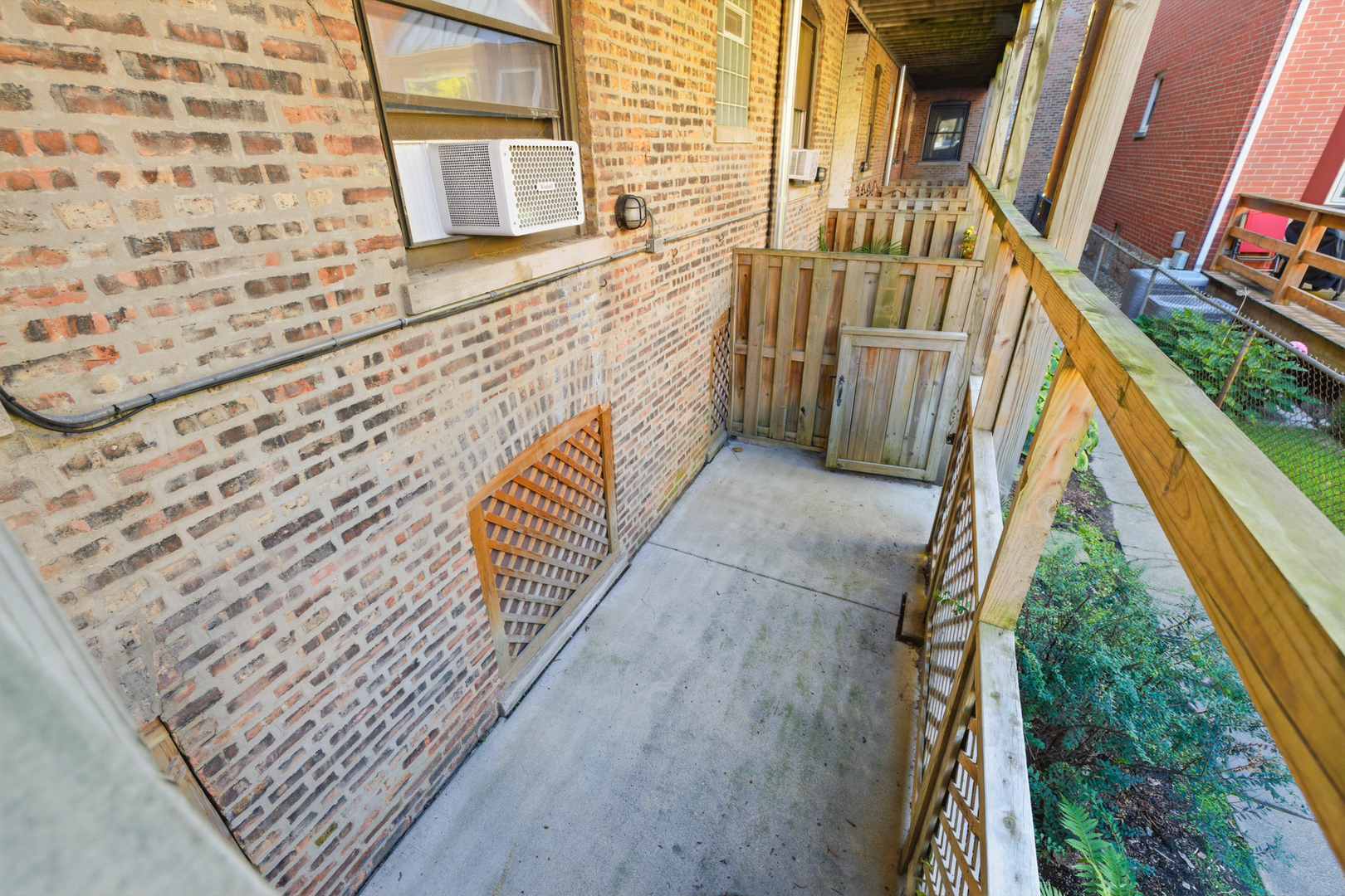 1014 West Barry Avenue, Unit 1 Chicago, IL 60657 - Photo 12 of 17 a view of balcony with wooden floor and fence