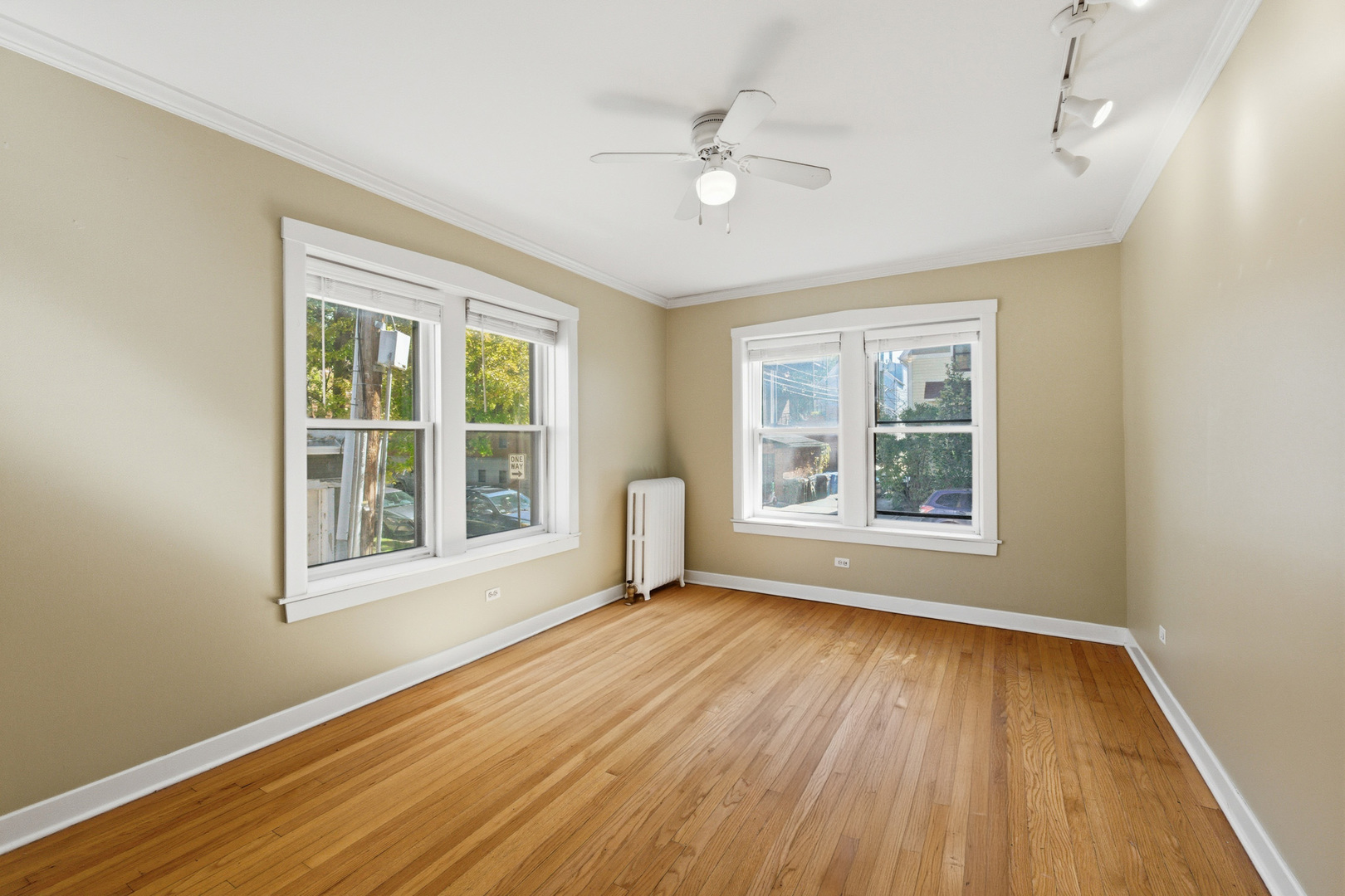1014 West Barry Avenue, Unit 1 Chicago, IL 60657 - Photo 3 of 17 a view of an empty room with wooden floor and a window