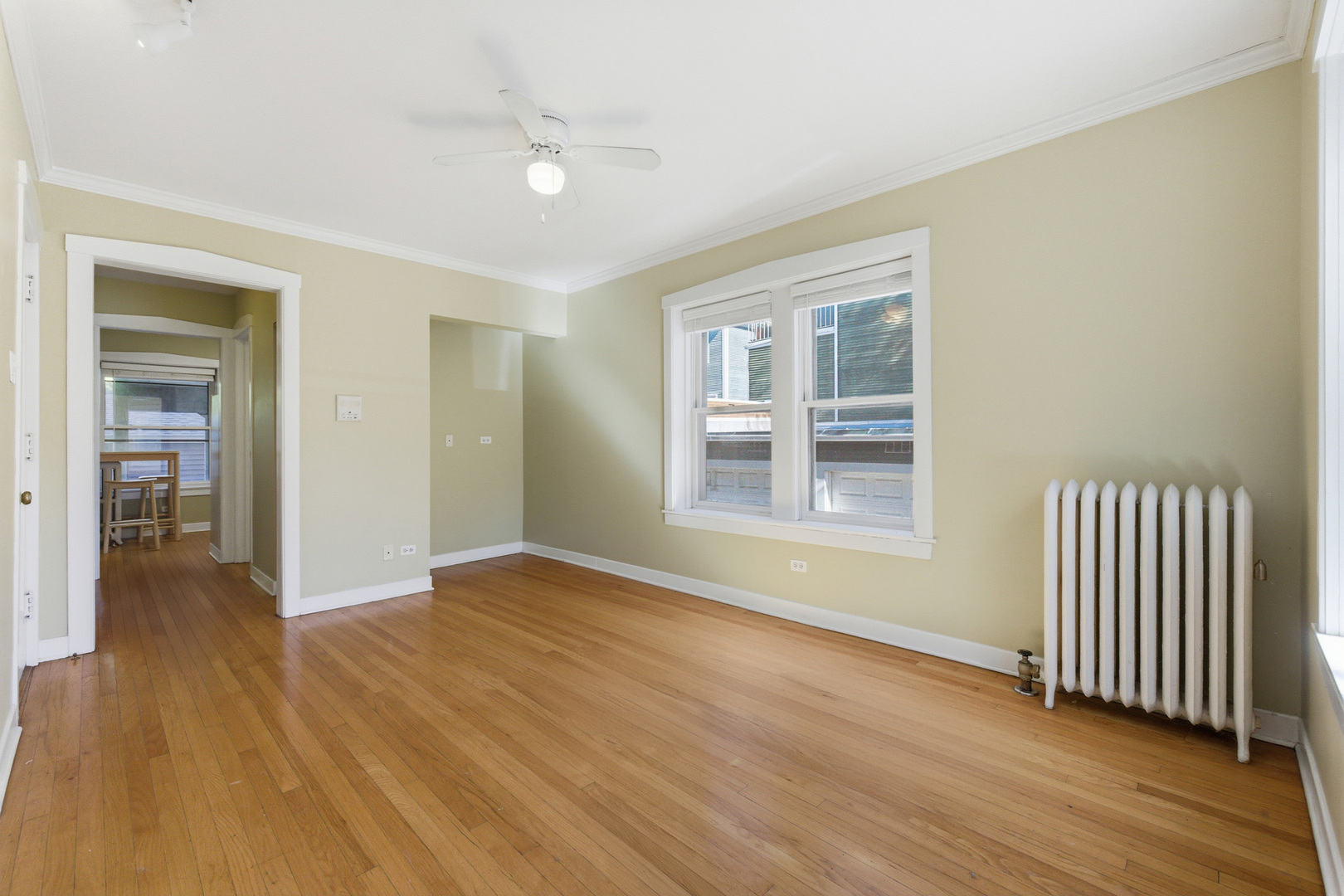 1014 West Barry Avenue, Unit 1 Chicago, IL 60657 - Photo 4 of 17 an empty room with wooden floor and windows