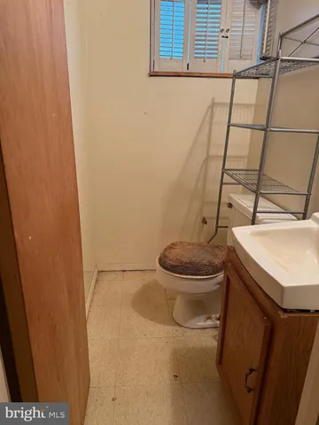 a white toilet sitting next to a sink