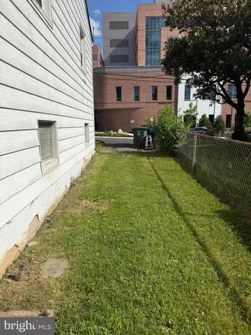 a view of a white house with a yard and plants