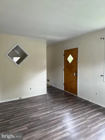 an empty room with wooden floor and closet