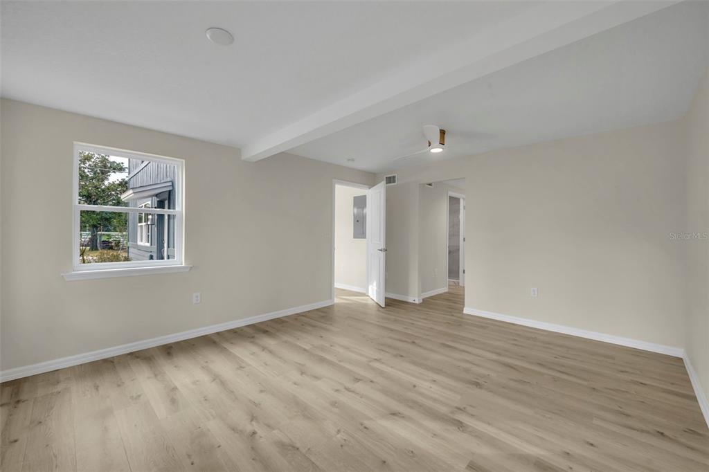 31201 Merry Road Tavares, FL 32778 - Photo 24 of 40 a view of an empty room with wooden floor and a window