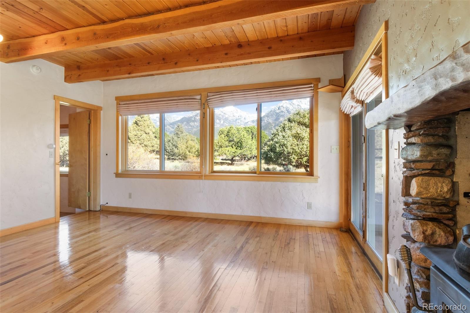 1507 Wagon Wheel Road Crestone, CO 81131 - Photo 12 of 50 a view of hallway with a large window and wooden floor