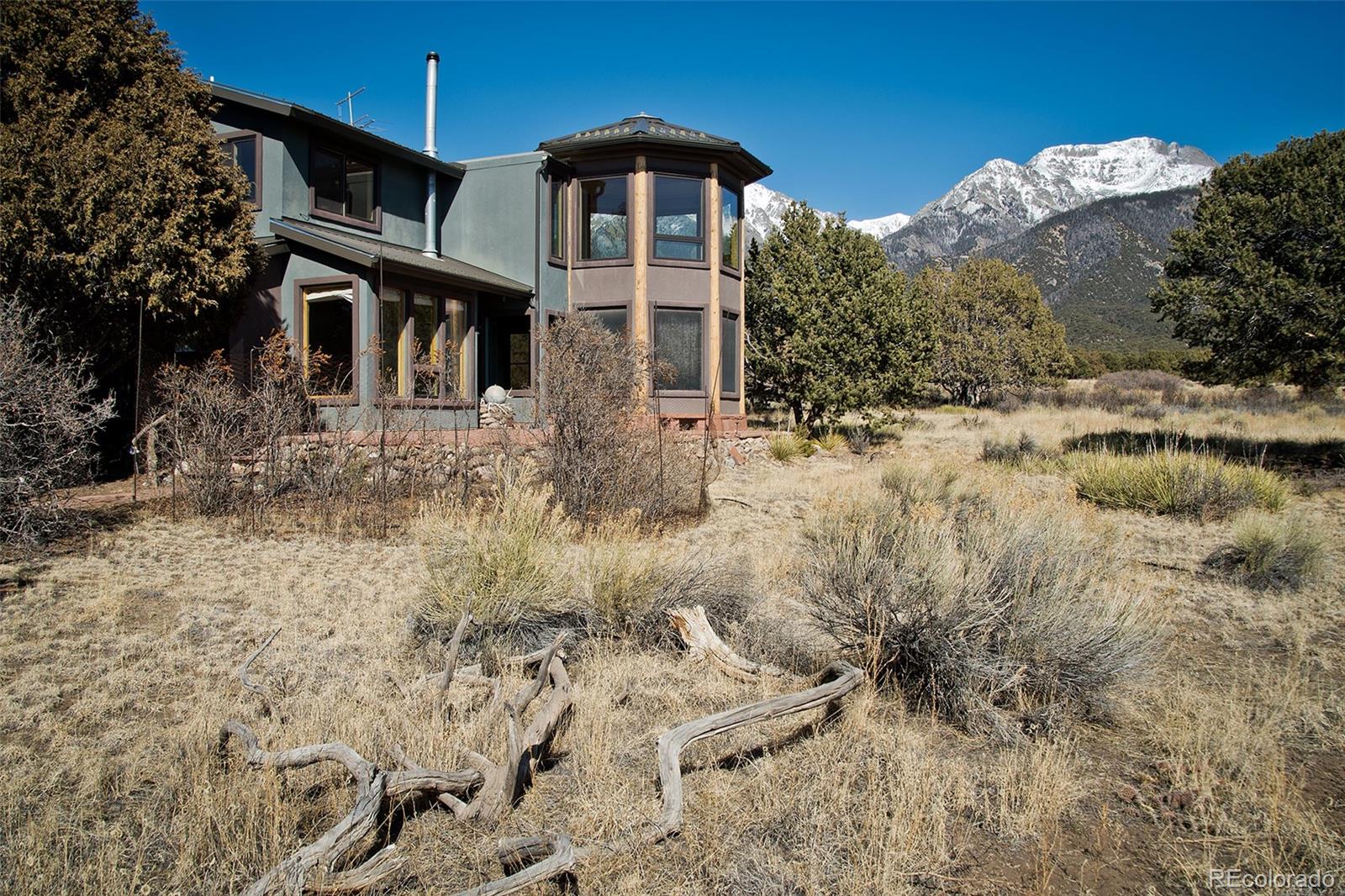 1507 Wagon Wheel Road Crestone, CO 81131 - Photo 44 of 50 a front view of a house with a yard